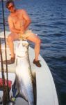 A tired, but happy, angler poses with his prize tarpon.