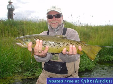 Capt. Rick Grassett with a Stone Creek hopper fly brown trout