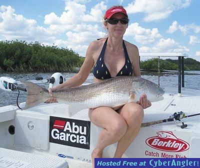 Kim's Rideout holds a big redfish she caught while fishing with Capt. Joe