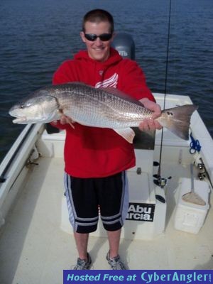 Evin hold up one of many redfish released