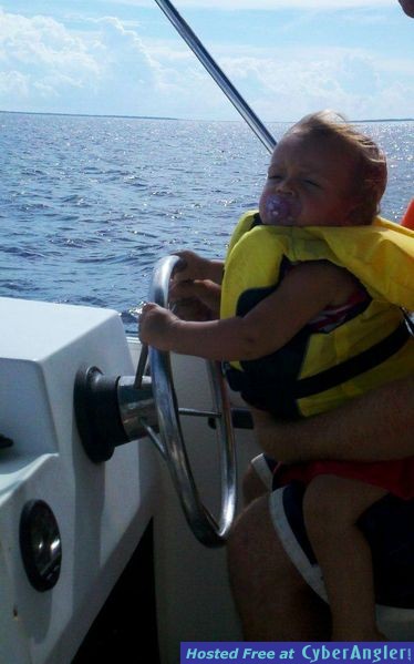 At the helm.