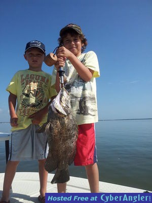 Austin and Hunter display a triple tail caught with Capt. Joe Porcelli