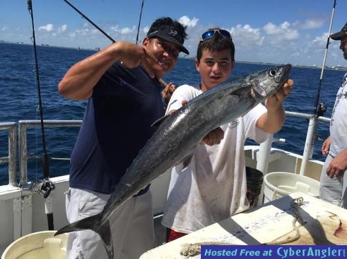 Capt Tito with a big kingfish caught aboard the Catch My Drift