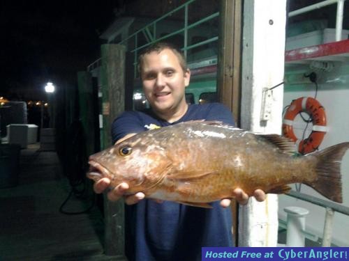 Brandon with a monster mangrove snapper caught night anchor fishing on the