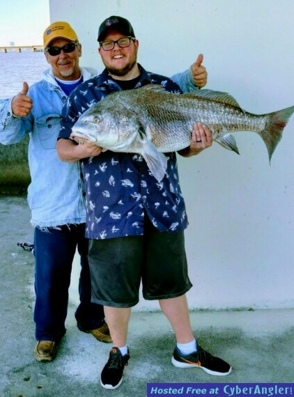 Captn_and_crew_happy_to_catch_bull_red