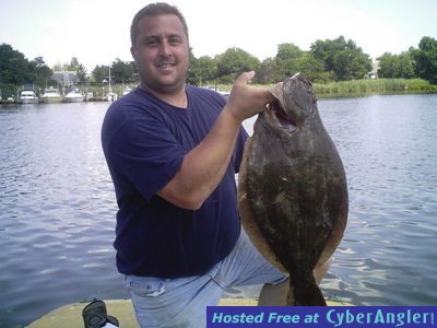 BRIAN WITH A 10 1/4 LB. FLUKE