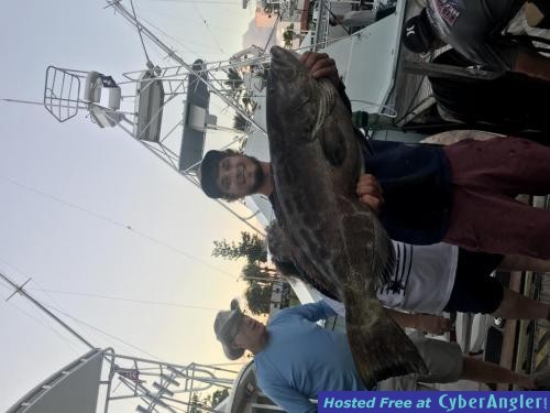 Alex_with_a_monster_grouper_caught_with_New_Lattitude_Sportfishing