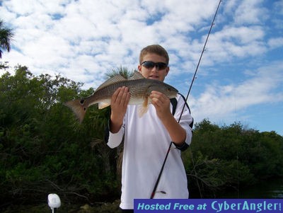 Landon poses with his first redfish